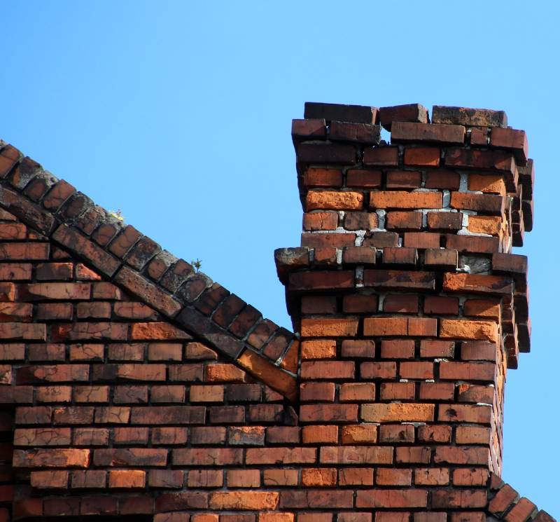 Damaged chimney on an Lemon Grove home showing cracks and missing mortar